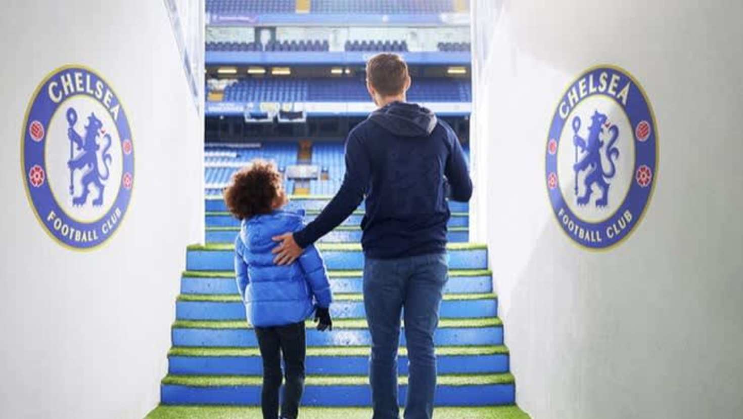 Parent and child walking down the players’ tunnel at Stamford Bridge on the Chelsea FC Stadium Tour
