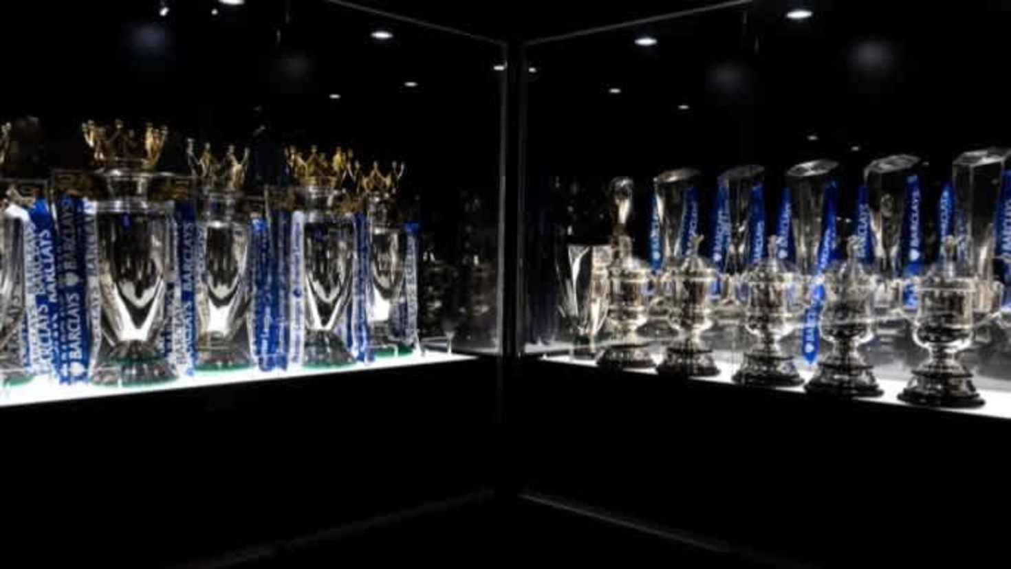 Chelsea FC trophy room showcasing Premier League, Champions League, and domestic cup trophies