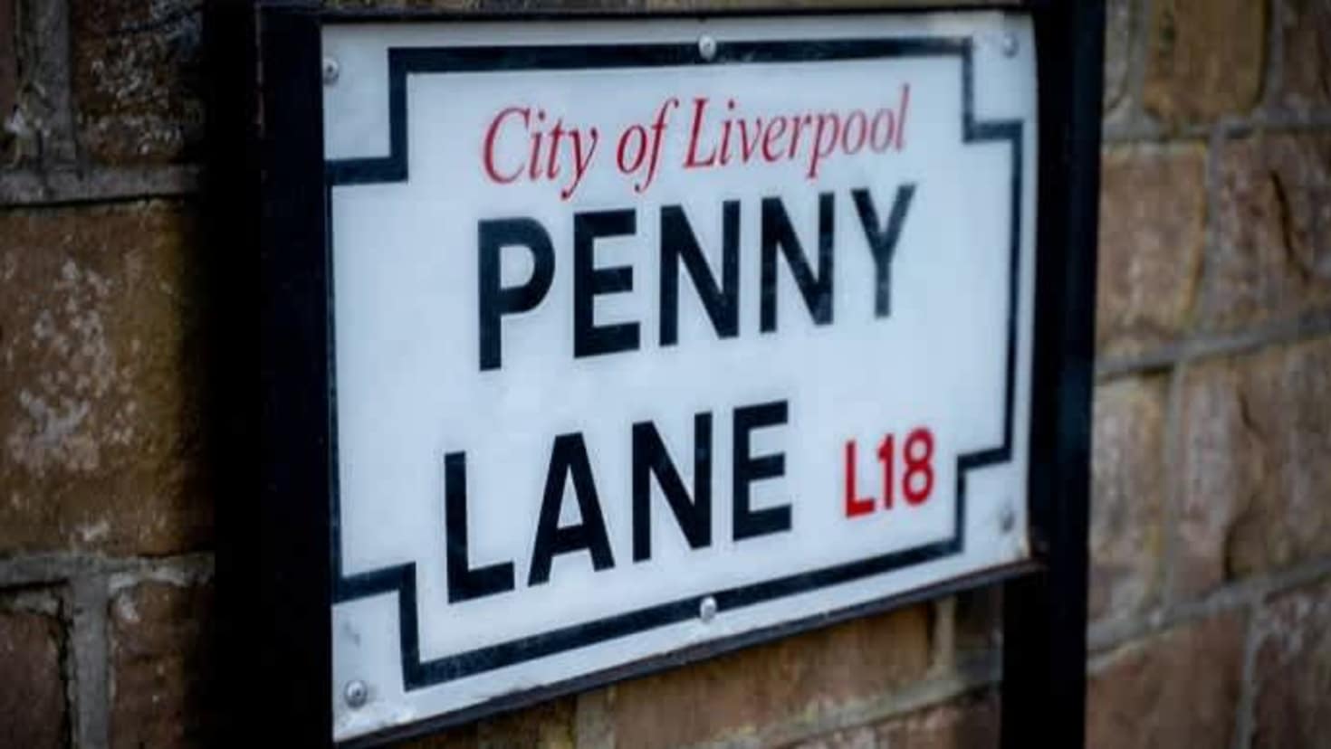 Close‑up of Penny Lane street sign in Liverpool, featured on the Magical Mystery Tour.