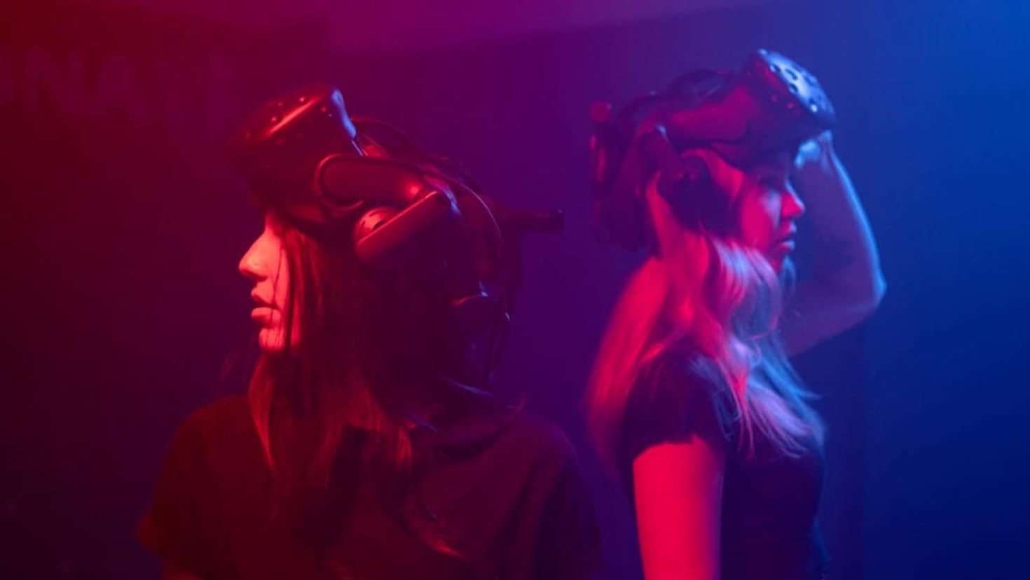 Two players in red and blue lighting preparing for multiplayer VR experience at DNA VR Camden Two players in red and blue lighting preparing for multiplayer VR experience at DNA VR Camden