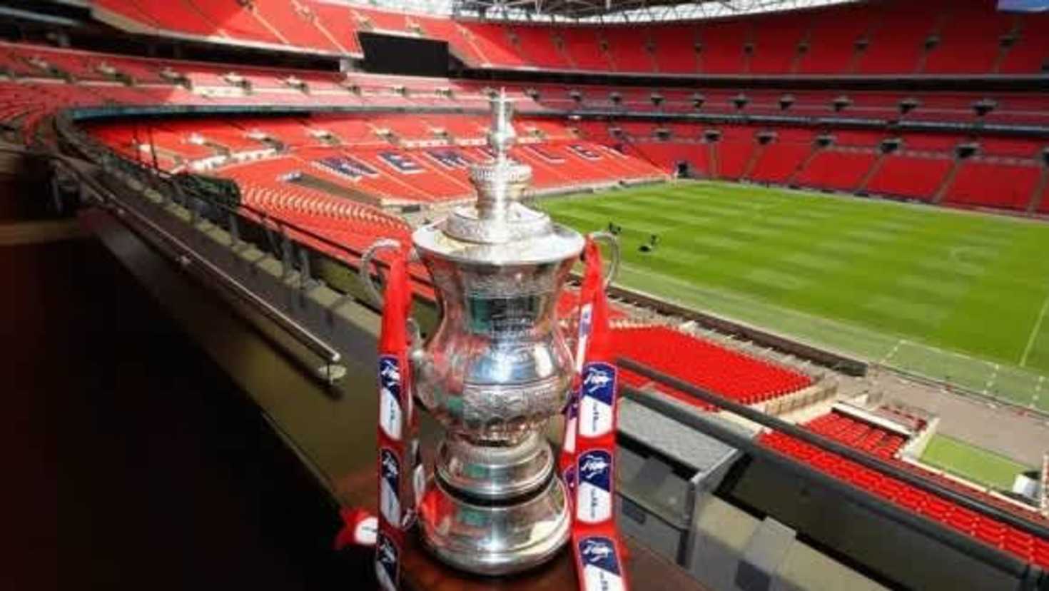 FA Cup trophy on display at Wembley Stadium overlooking the pitch
