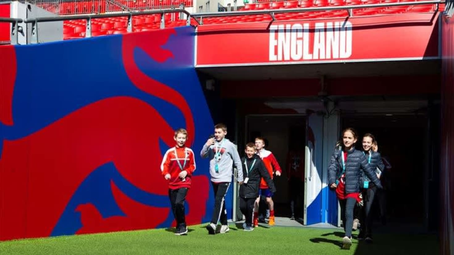 Children walking through Wembley players’ tunnel during stadium tour experience