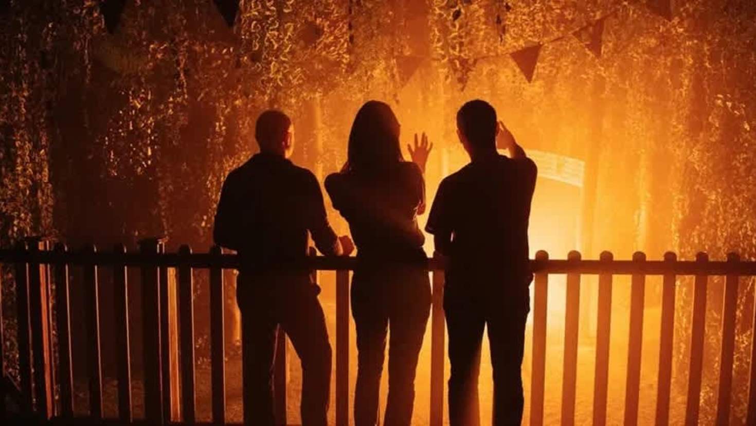 Guests stand in silhouette before a glowing orange set piece at Jeff Wayne’s War of the Worlds immersive show, part of the experience with Jeff Wayne’s War of the Worlds tickets. Guests stand in silhouette before a glowing orange set piece at Jeff Wayne’s War of the Worlds immersive show, part of the experience with Jeff Wayne’s War of the Worlds tickets.