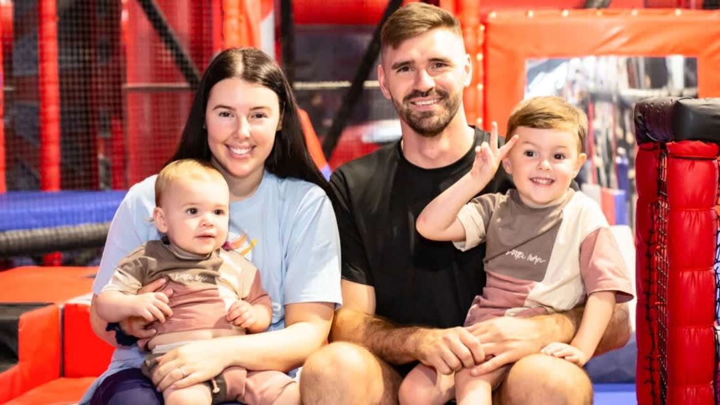 family smiling at ninja warrior