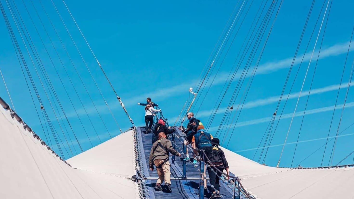 Climbers ascending the steep rooftop walkway during the Up at The O2 London adventure