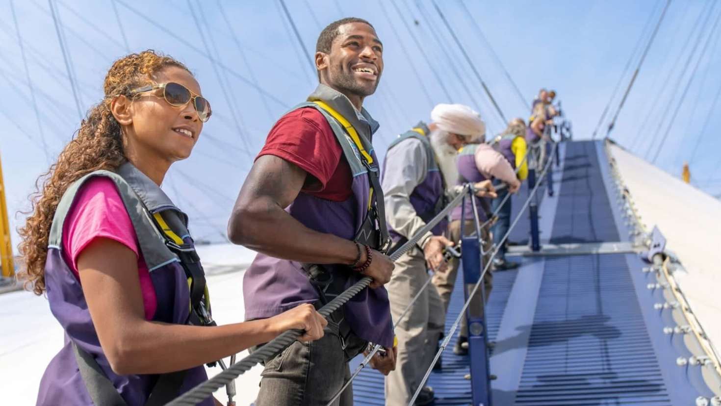 Visitors enjoying the guided climb on Up at The O2 rooftop walk in London.
