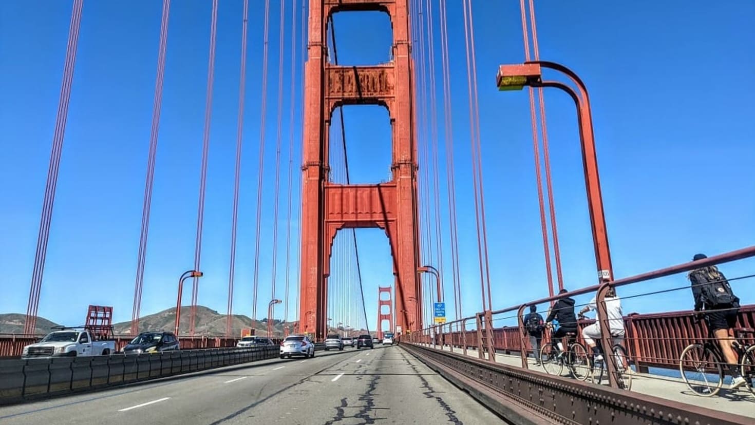 Golden Gate Bridge spanning the bay with blue water below Golden Gate Bridge spanning the bay with blue water below