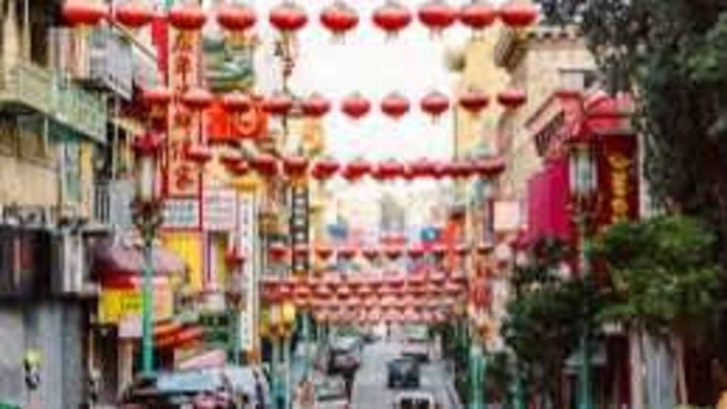 Busy street in Chinatown with traditional architecture and lanterns Busy street in Chinatown with traditional architecture and lanterns