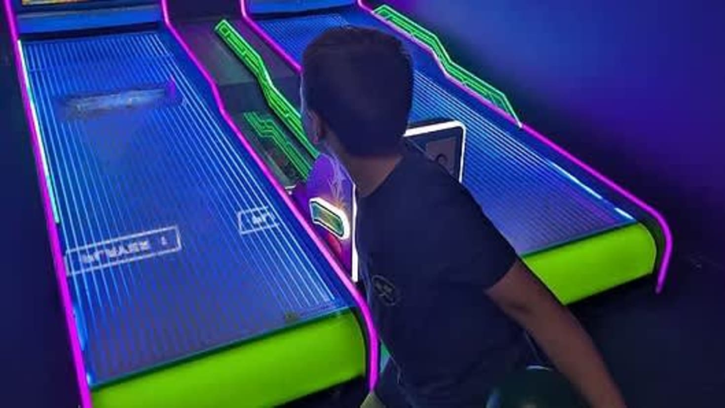 Group of friends playing arcade games together
