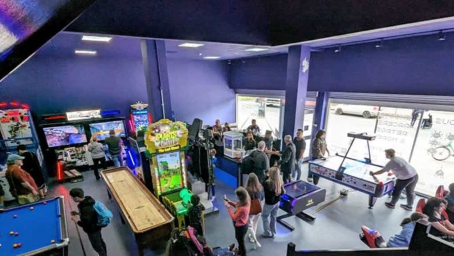 Rows of colourful arcade machines in a gaming lounge Rows of colourful arcade machines in a gaming lounge