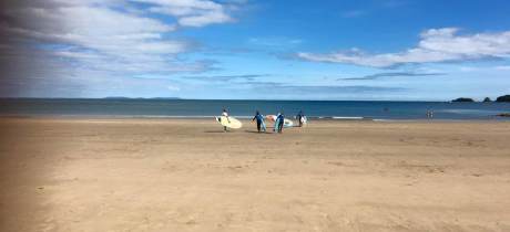 People surfing on beach at Good Trails in Saundersfoot