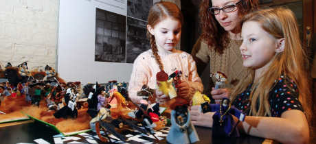 Mum and girls paying with dolls at National Civil War Centre - Newark Museum