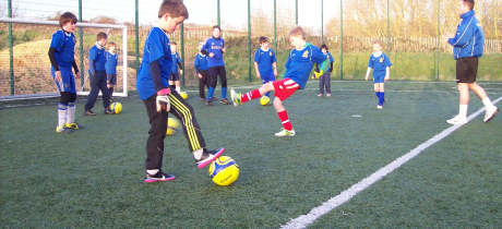 Kids playing football at Two Riversmeet Leisure Complex in Christchurch