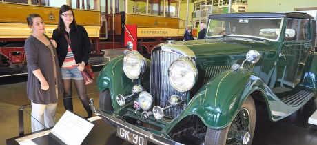 Family looking at classic car at Glasgow Riverside Museum