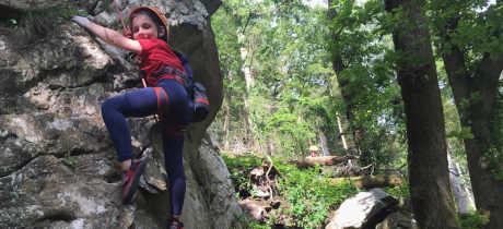 A young girl climbs a rock face at Adventure Beyond in LLandysul