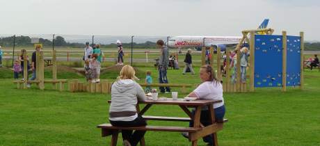 Families picnicking and playing at The Runway Visitor Park in Altrincham