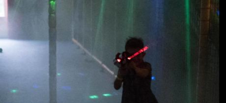 Boy playing laser tag at Play Planet Soft Playcentre in Hereford