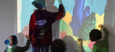 People drawing on wall at Dovecot Studios in Edinburgh