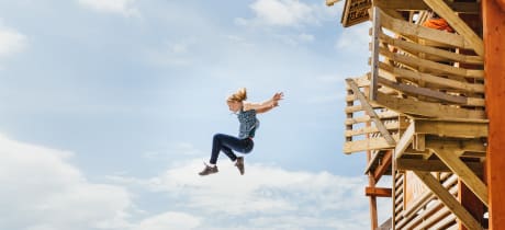 Girl jumping off platform at Hangloose Adventures in Bodelva