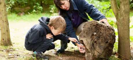 Mum and son inspect boulder at Shropshire Hills Discovery Centre in Craven Arms