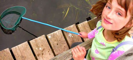 Girl with fishing net at Shropshire Hills Discovery Centre in Craven Arms