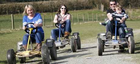 Family on roller racers at Quackers Indoor Soft Play Centre in Newbridge on Wye