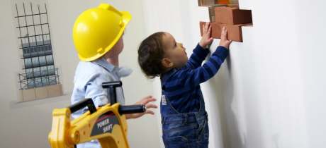 Kids roleplaying construction at Tots Town in Norwich