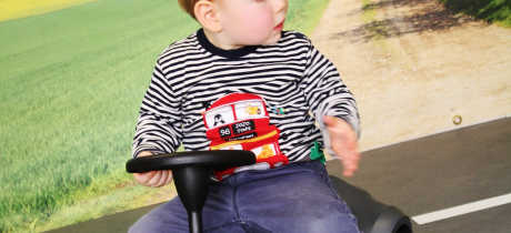 Boy on toy car at Tots Town in Norwich