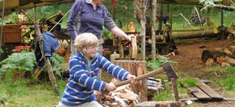 Boy cutting wood at Do It Outdoors in Comrie