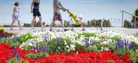 Family walking at Whitmore Bay in Barry Island