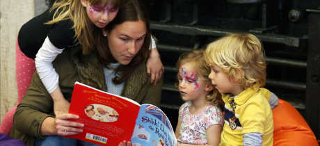 Family reading book at Palace of Holyroodhouse in Edinburgh