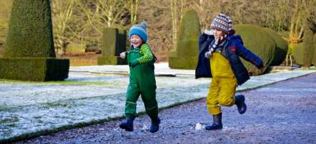 Children playing in the garden in winter at Sudbury Hall, Derbyshire