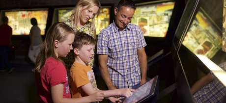 Family looking at interactive screen at Maritime Museum in Jersey