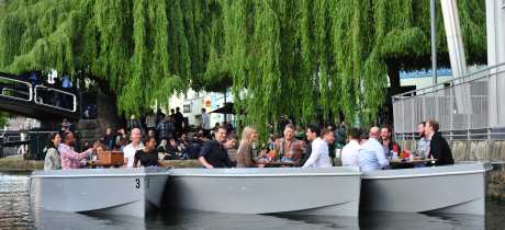 Visitors picnicking on boats at GoBoat London