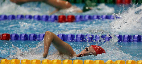 People swimming at London Aquatics Centre