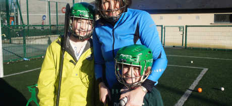 Family playing hockey at Experience Gaelic Games in Dublin