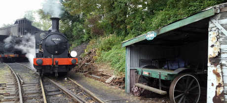 Steam train travelling at Bodmin and Wenford Railway