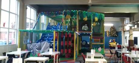 Indoor soft play frame and seating area at Jungle Mayhem in Radcliffe