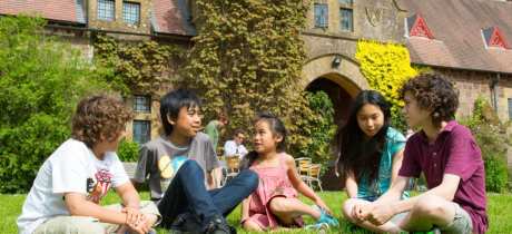 A group of kids sat on the grass at Knightshayes Court, photo credit National Trust/Tony Cobley