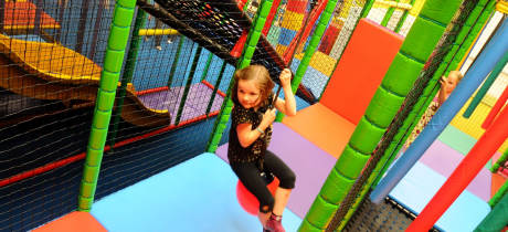 Girl playing on soft play frame at Tigers Indoor Play in Daventry