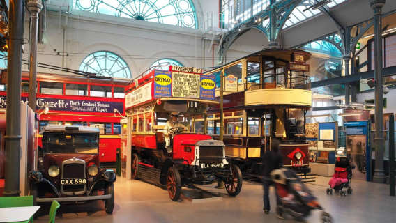 Vintage London buses and trams on display inside the London Transport Museum.