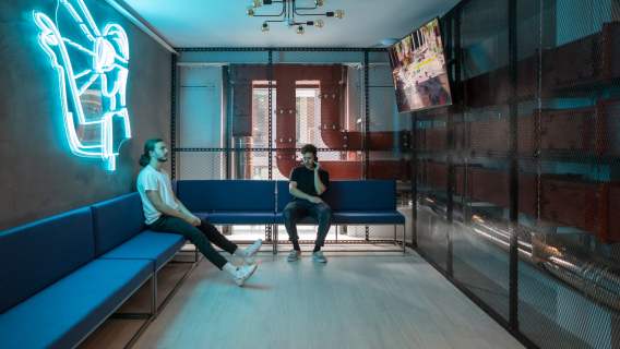 DNA VR Hammersmith lounge area with neon artwork and seating for ticketed visitors
