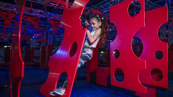 girl climbing obstacle course