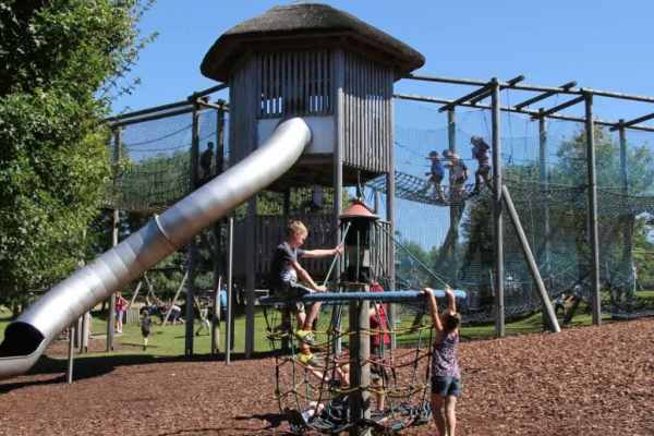 Children on climbing frame of large adventure playground Children on climbing frame of large adventure playground