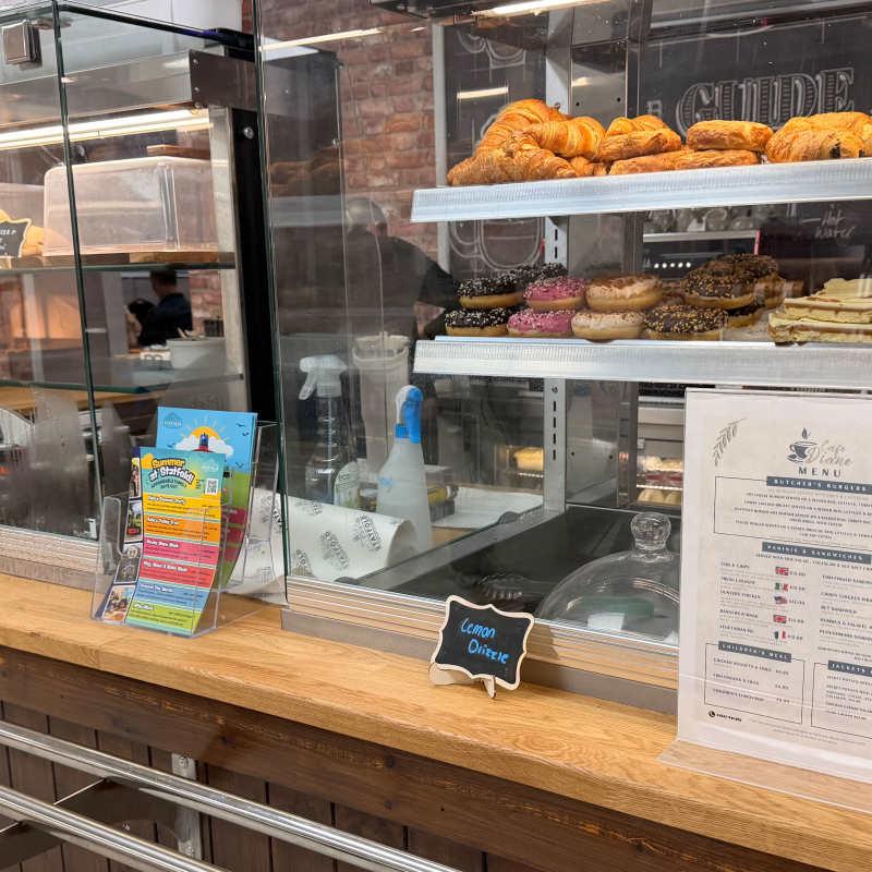 Counter in Diane’s Diner with sweet treats and hot food menu