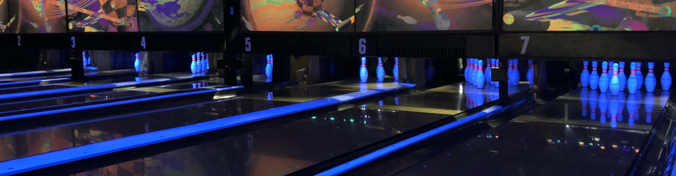 neon light bowling alley with bowling pins