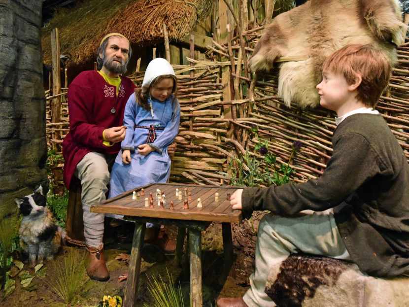 wax figures of viking family playing chess