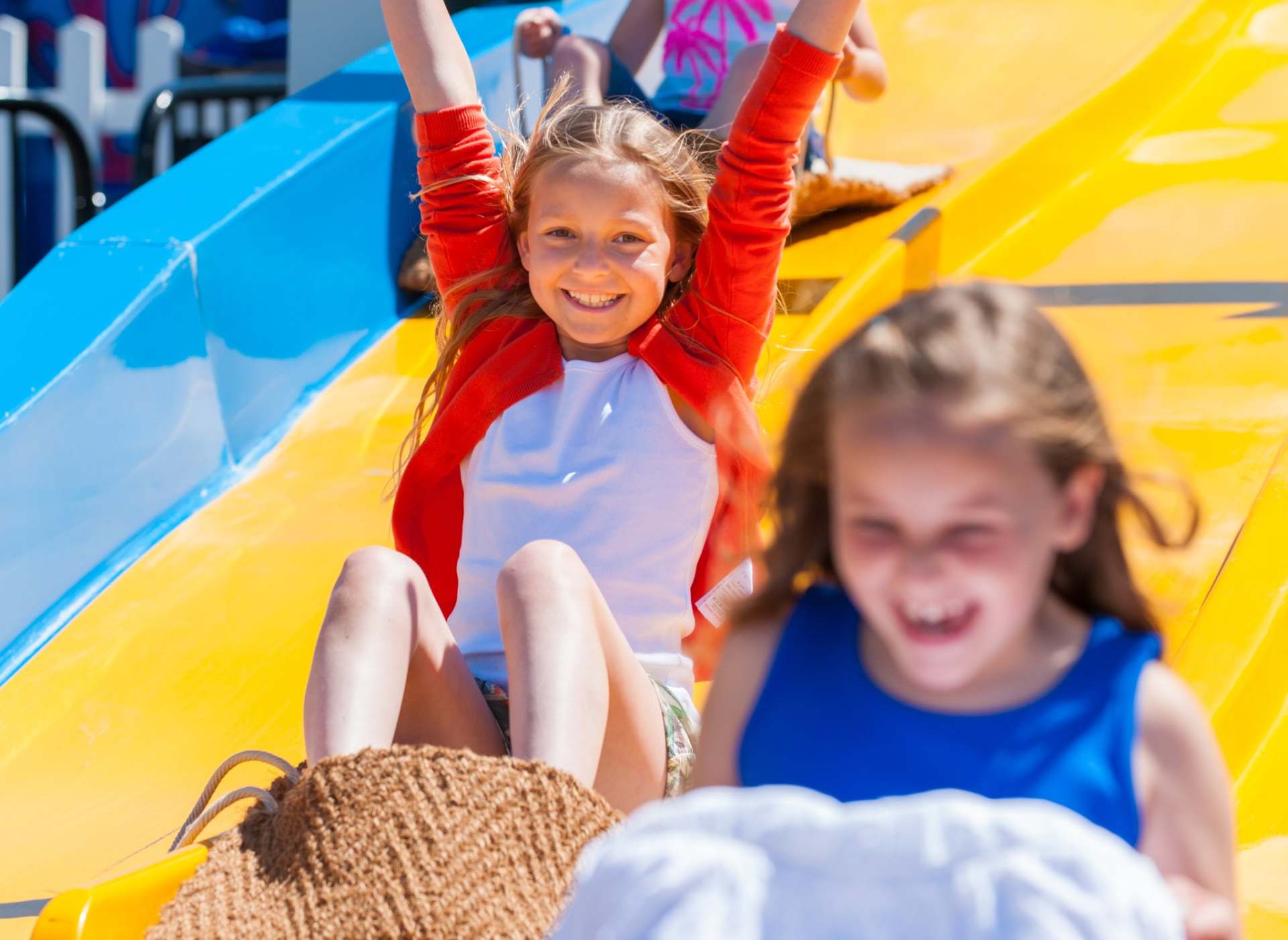 two children going down a slide