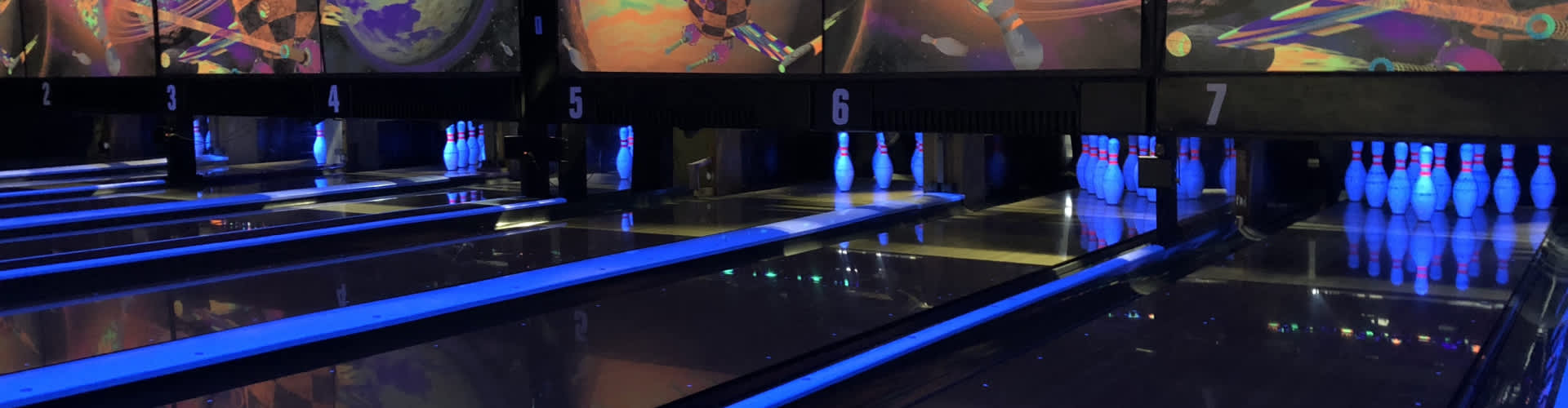 neon light bowling alley with bowling pins