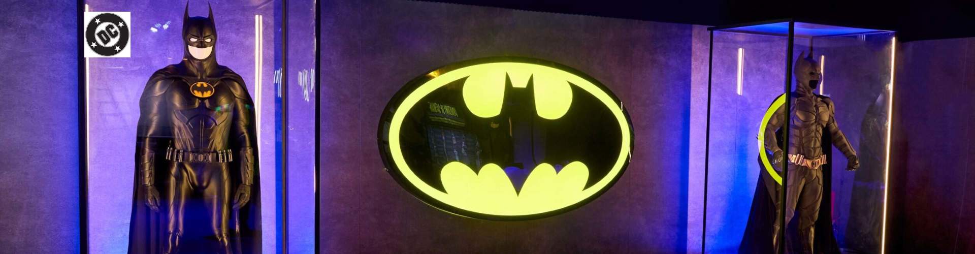 batman suits with neon batman sign in the middle 